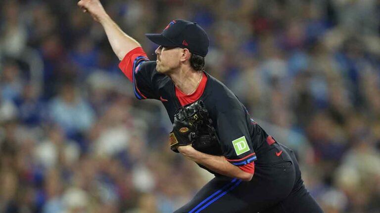 Shane Bieber receives a compliment from Aaron Boone before the game 3