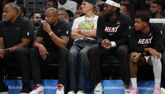 Tyler Hero and Bam Adebayo approach the floor