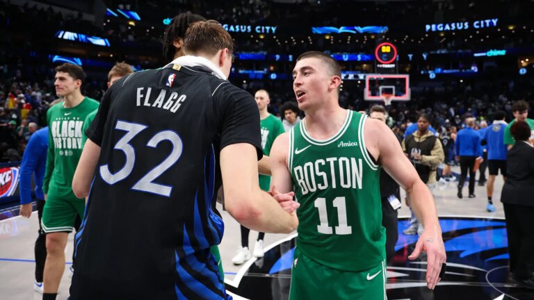 Peyton Pritchard catches the eye of Kaitlyn Clark during a Mavericks game